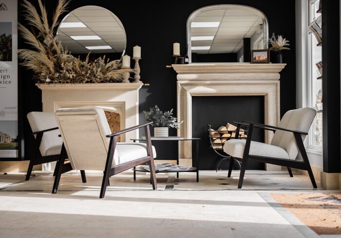 Decorative natural stone fireplace surrounds in a stylish showroom.