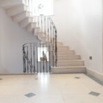 A spiral staircase made of english limestone, with iron railings for a truly unique and aesthetic style.