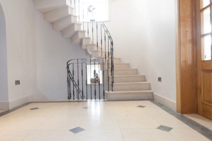 A spiral staircase made of english limestone, with iron railings for a truly unique and aesthetic style.