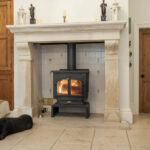 Stone fireplace with a dog lying in front of it