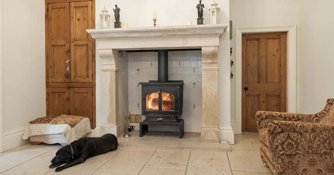Stone fireplace with a dog lying in front of it